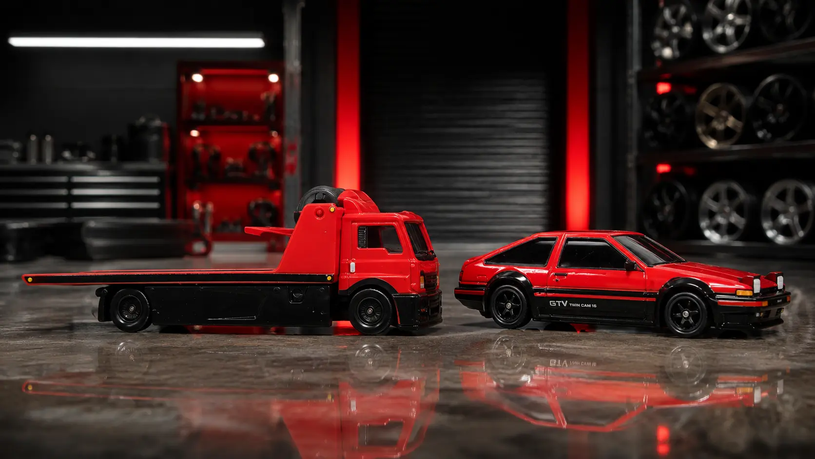 Toyota AE86 Sprinter Trueno beside Fleet Street Team Transport in a Japanese miniature workshop