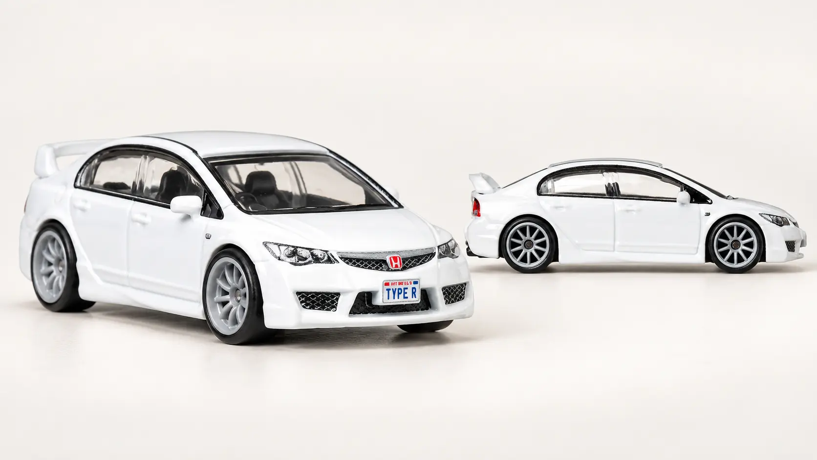 Illustrative front three-quarter and side views of a white Honda Civic Type R FD2 miniature sedan